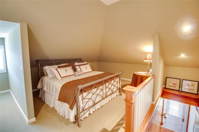 bedroom with vaulted ceiling and carpet