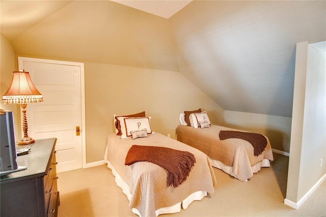 carpeted bedroom featuring lofted ceiling