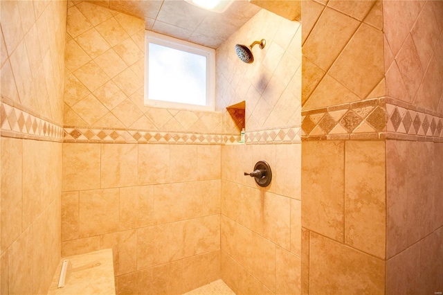 bathroom with a tile shower