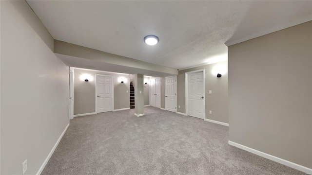 unfurnished bedroom with light carpet and a textured ceiling