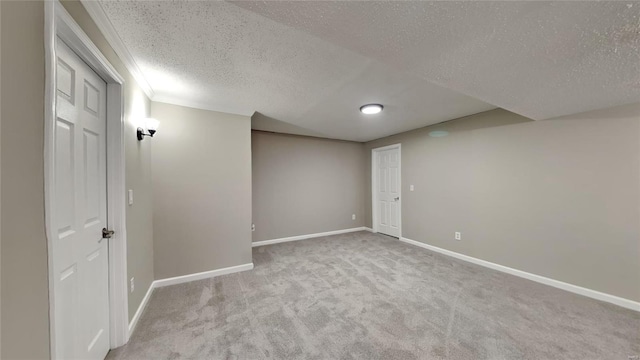 carpeted empty room with a textured ceiling