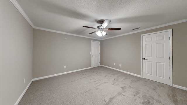 spare room with ceiling fan, light carpet, and crown molding