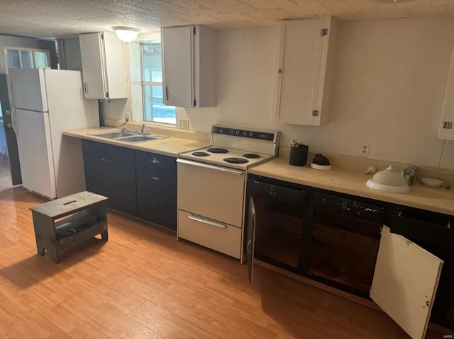 kitchen featuring white cabinets, white appliances, light wood-type flooring, and sink