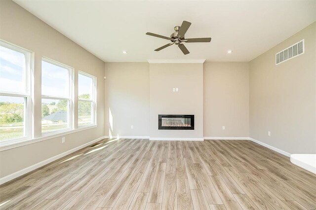 unfurnished living room featuring ceiling fan and light hardwood / wood-style flooring