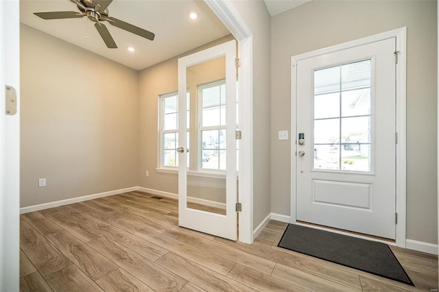 entryway featuring french doors, ceiling fan, and light hardwood / wood-style floors