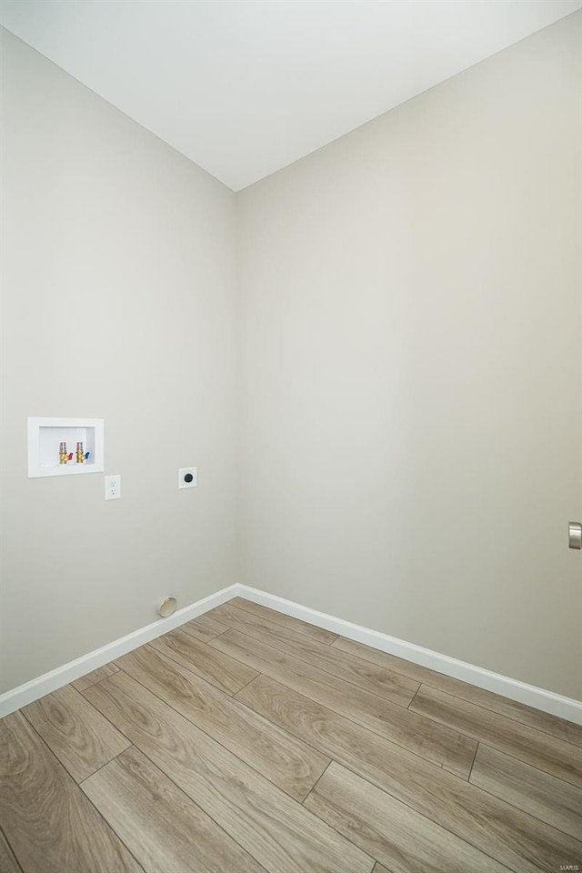 laundry room featuring hookup for a washing machine, electric dryer hookup, and light wood-type flooring