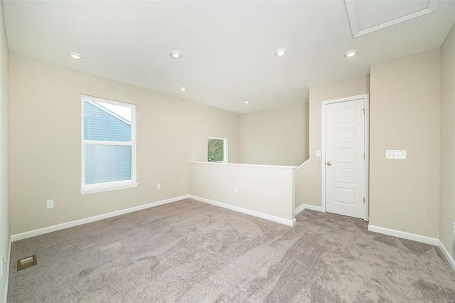 unfurnished room with light carpet