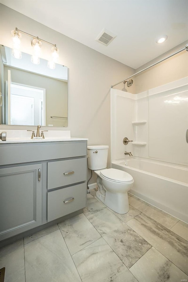 full bathroom featuring vanity, tub / shower combination, and toilet