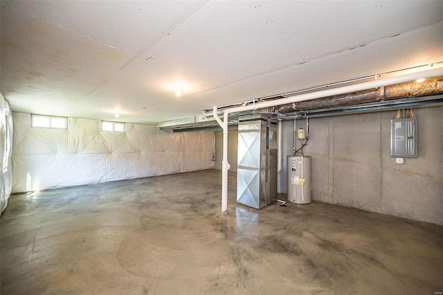 basement featuring electric panel, electric water heater, and heating unit