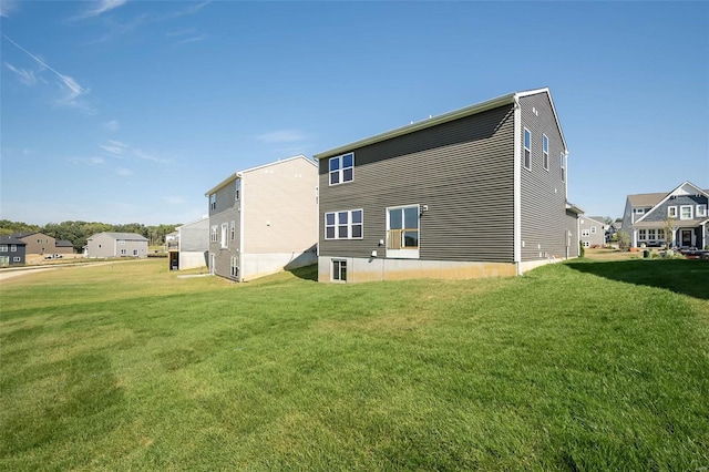 rear view of property featuring a lawn