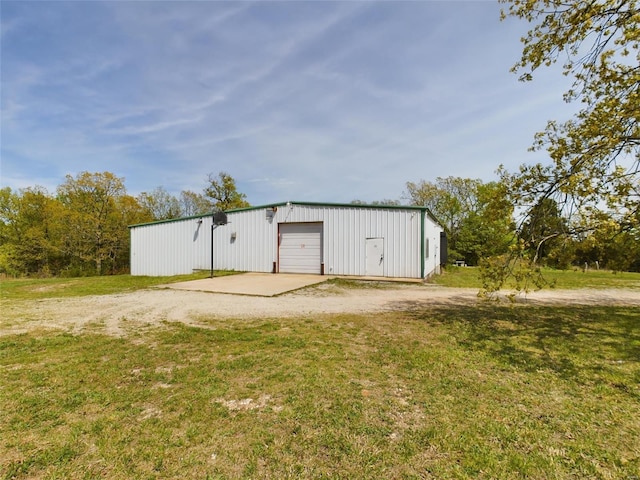 view of shed / structure featuring a yard and a garage