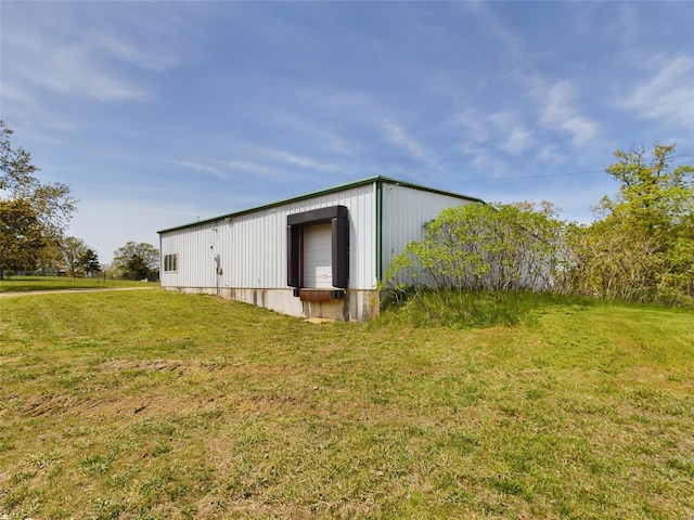 view of shed / structure with a yard and a garage