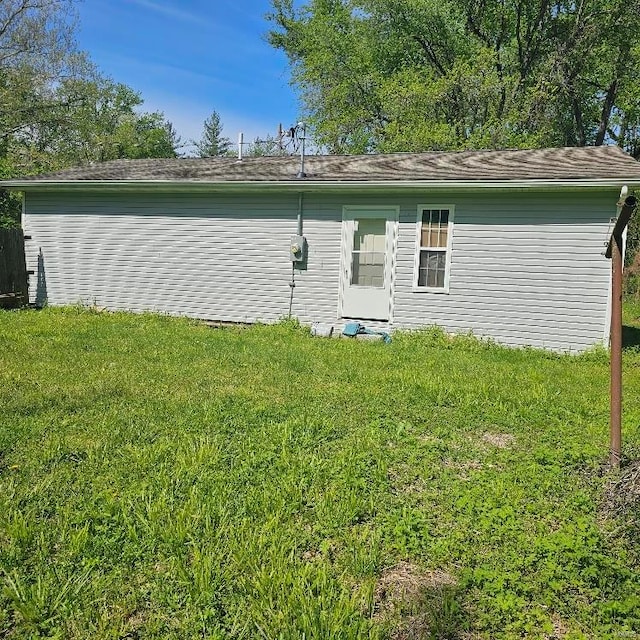 back of house with a lawn