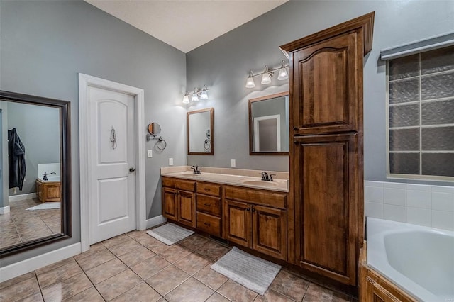 bathroom featuring a tub, tile flooring, and double sink vanity