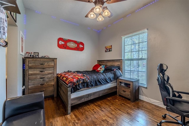 bedroom featuring ceiling fan and dark wood-type flooring