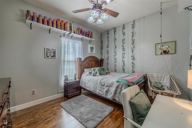 bedroom with ceiling fan and dark wood-type flooring