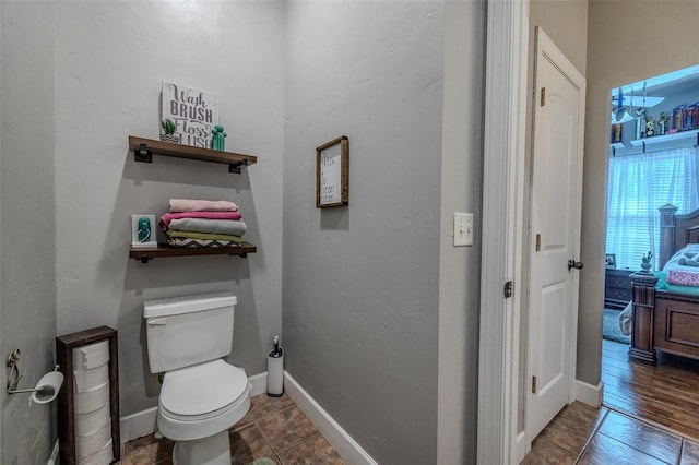 bathroom featuring tile floors and toilet