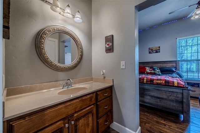 bathroom with ceiling fan, vanity, and hardwood / wood-style flooring