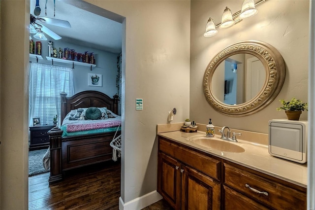 bathroom with hardwood / wood-style flooring, vanity, and ceiling fan