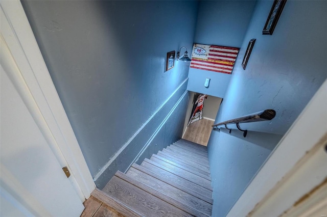 staircase featuring wood-type flooring