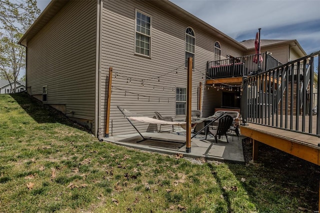 rear view of property featuring a patio and a lawn