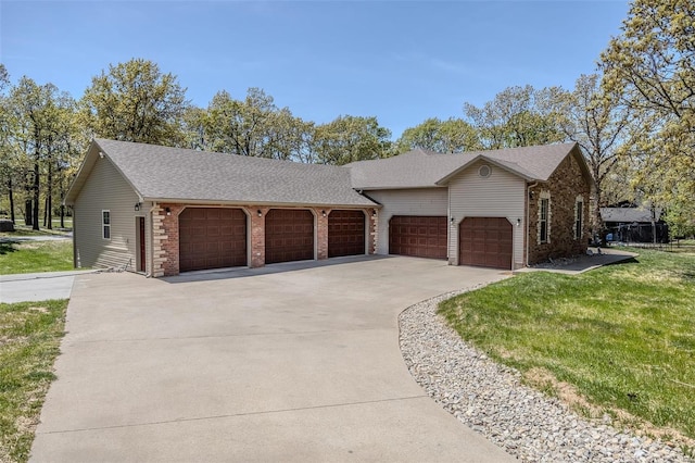 single story home featuring a garage and a front lawn