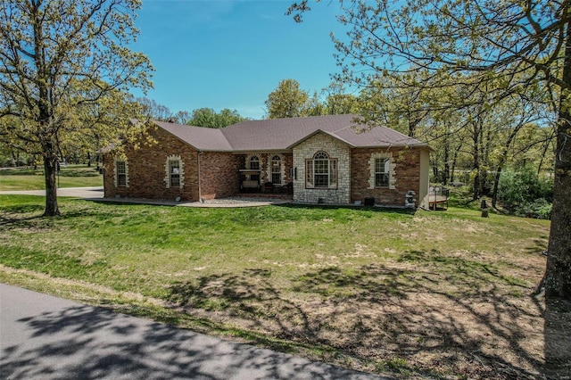 ranch-style home with a front lawn