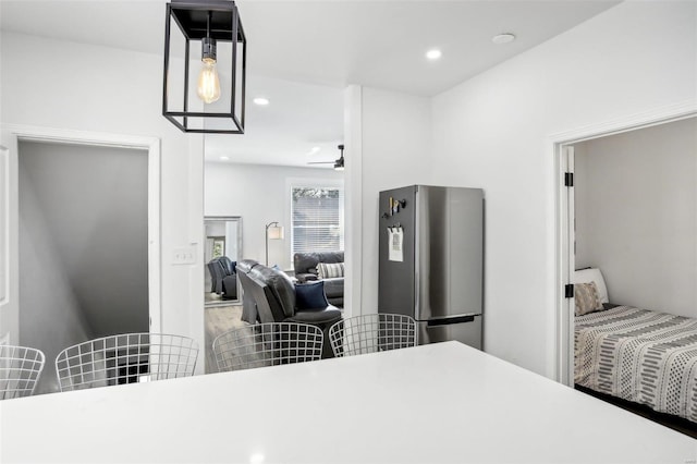 bedroom featuring stainless steel refrigerator