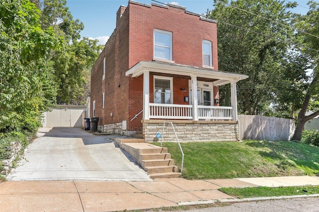 view of front of home with a front lawn and covered porch