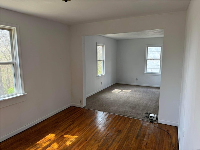 spare room with plenty of natural light and hardwood / wood-style floors