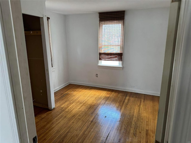 unfurnished bedroom featuring hardwood / wood-style flooring