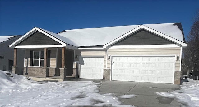 view of front of home featuring covered porch and a garage