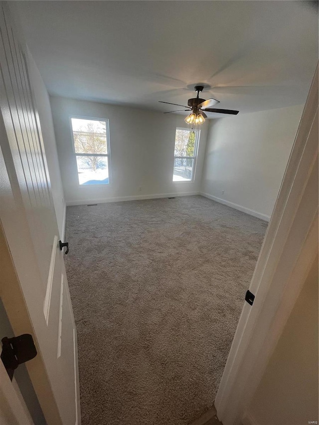 spare room featuring carpet floors and ceiling fan