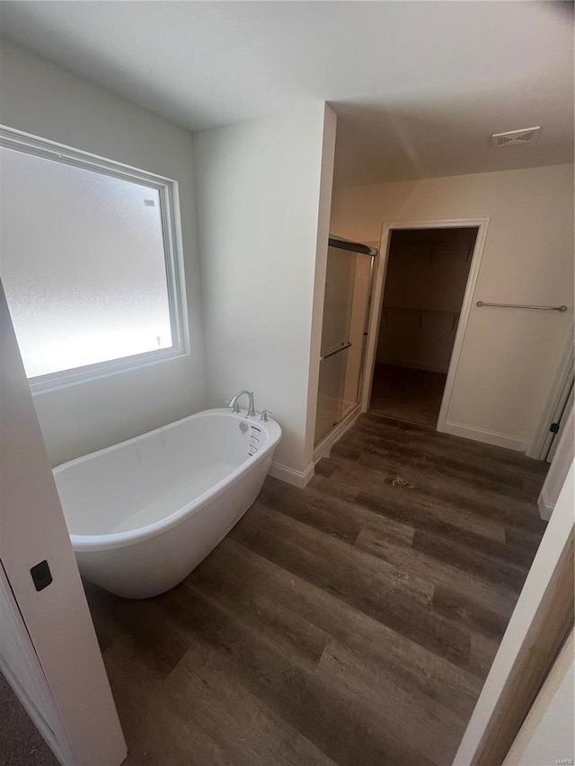 bathroom featuring hardwood / wood-style flooring and separate shower and tub