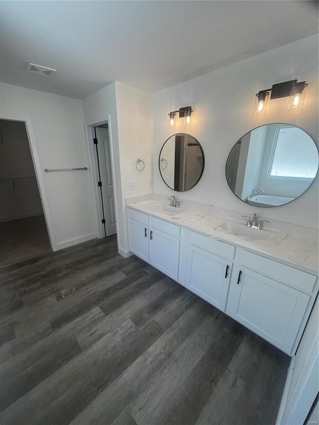 bathroom with vanity and wood-type flooring