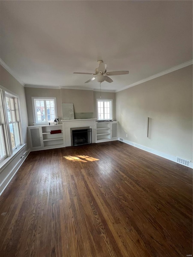 unfurnished living room with crown molding, dark hardwood / wood-style flooring, and ceiling fan