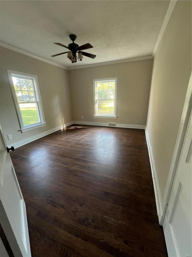 empty room with crown molding, dark hardwood / wood-style flooring, and ceiling fan