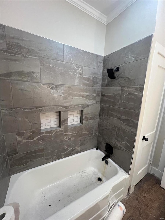 bathroom featuring tiled shower / bath, crown molding, and wood-type flooring