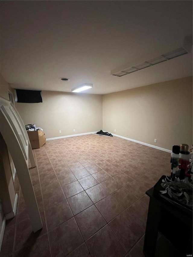 basement featuring dark tile patterned floors