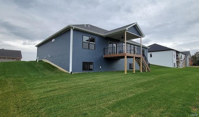 back of property featuring a yard and a deck