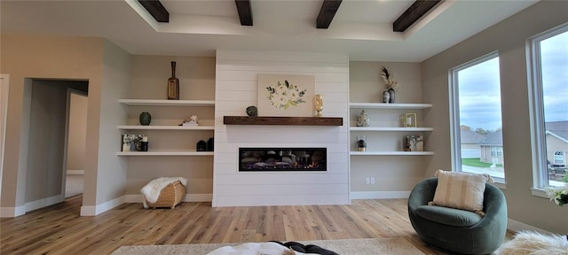 sitting room with light wood-type flooring and a fireplace