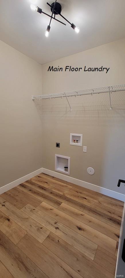 laundry area featuring hookup for an electric dryer, hardwood / wood-style floors, and washer hookup