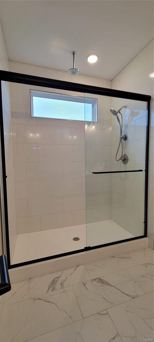 bathroom featuring a shower with shower door