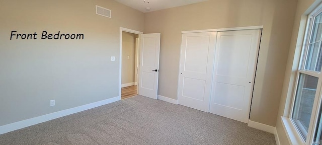 unfurnished bedroom with carpet flooring and a closet