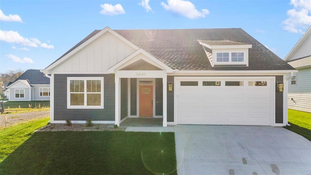 view of front of property featuring a garage and a front lawn