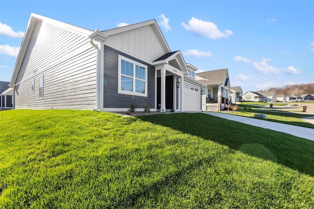 view of front of home with a front yard and a garage