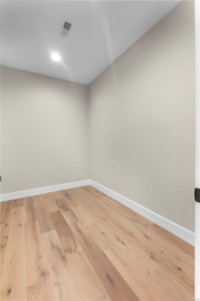 unfurnished room with wood-type flooring