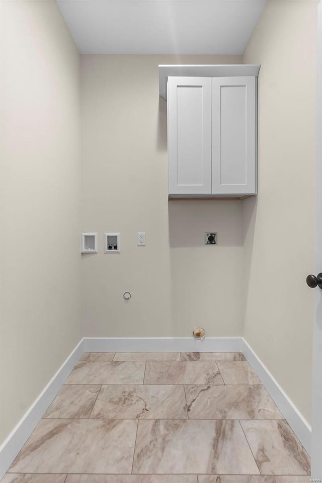 laundry area featuring cabinets, electric dryer hookup, hookup for a gas dryer, and hookup for a washing machine