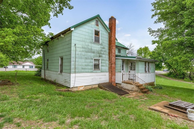 rear view of house with a lawn