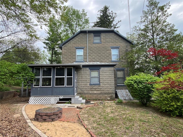 back of property featuring a sunroom